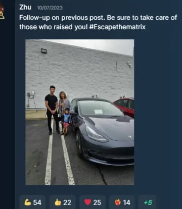 Two people standing beside silver sports car